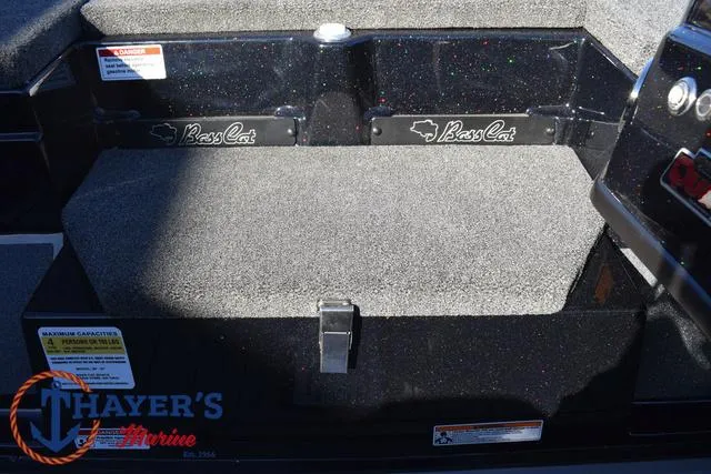 Slide: The Image of 2025 Bass Cat Puma STS boat interior with carpeted storage area. - 18