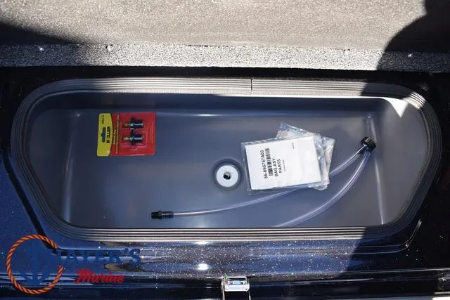 Slide: The Image of 2025 Bass Cat Puma STS storage compartment with accessories and tubing. - 19