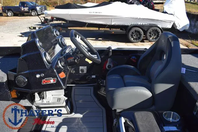 Slide: The Image of 2025 Bass Cat Puma STS boat interior with steering wheel and dashboard at Thayer's Marine. - 25