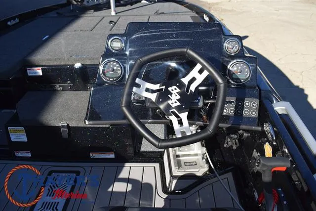 Slide: The Image of 2025 Bass Cat Puma STS boat dashboard with steering wheel and gauges. - 26