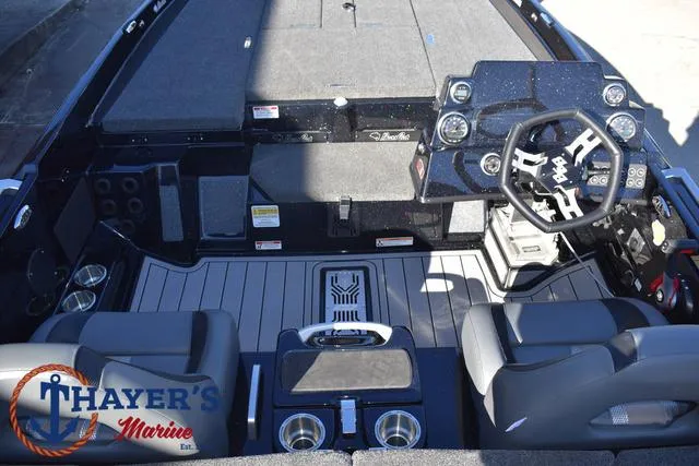 Slide: The Image of 2025 Bass Cat Puma STS boat interior with steering wheel and seating at Thayer's Marine. - 27
