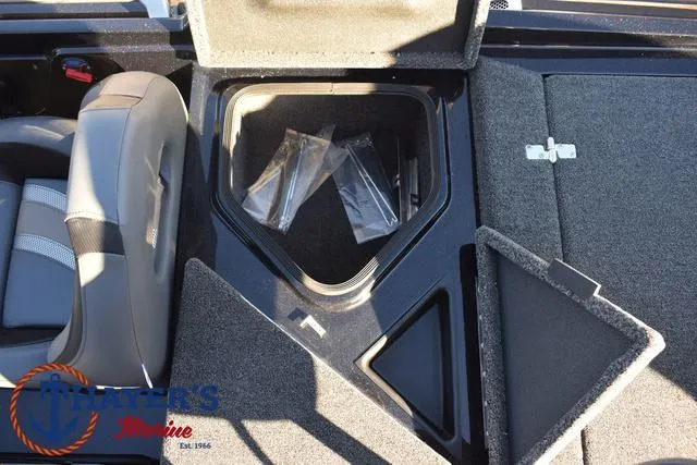 Slide: The Image of 2025 Bass Cat Puma STS boat storage compartments with gray seating and carpeted interior. - 31