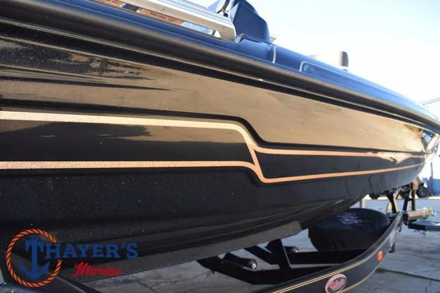 Slide: The Image of 2025 Bass Cat Puma STS boat with sleek black and gold detailing. - 42