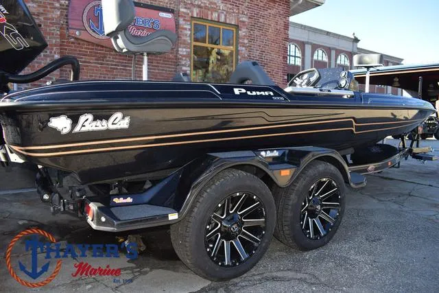 Slide: The Image of 2025 Bass Cat Puma STS boat with sleek black design and custom wheels. - 45