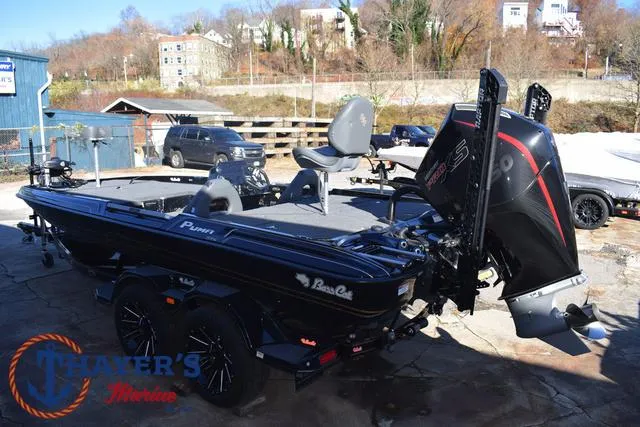 Slide: The Image of 2025 Bass Cat Puma STS boat with powerful engine, parked outdoors. - 9