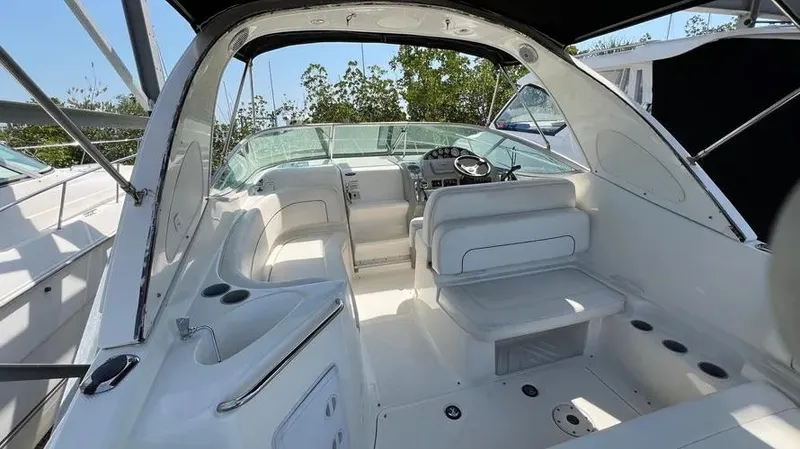 Slide: The Image of 2011 Bayliner 285 Cruiser interior with seating and helm, featuring sleek white design. - 13