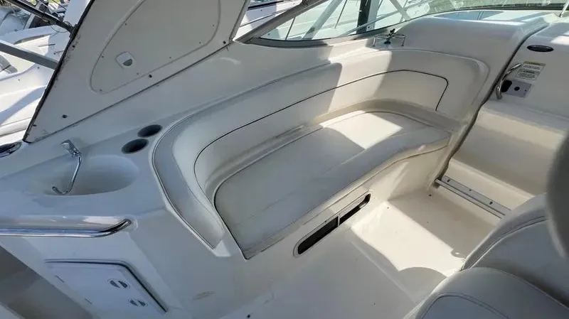 Slide: The Image of 2011 Bayliner 285 Cruiser interior with white seating and built-in cup holders. - 14