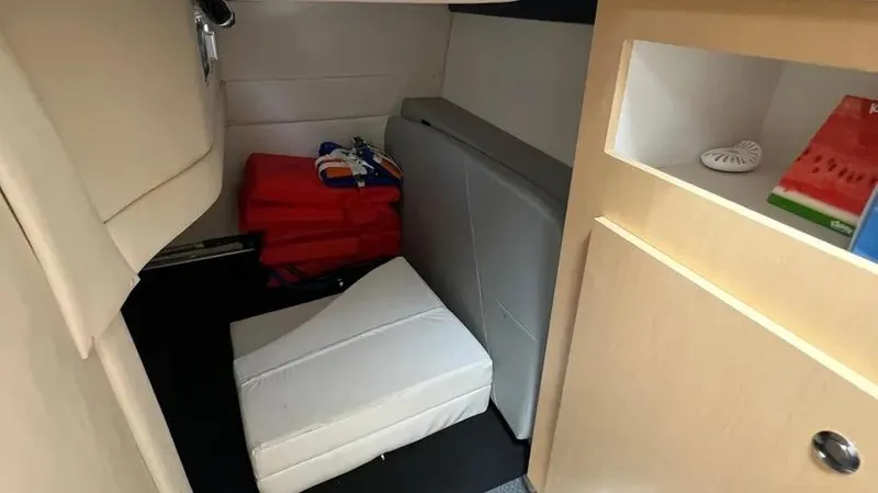 Slide: The Image of Interior cabin of 2011 Bayliner 285 Cruiser with seating and storage. - 21