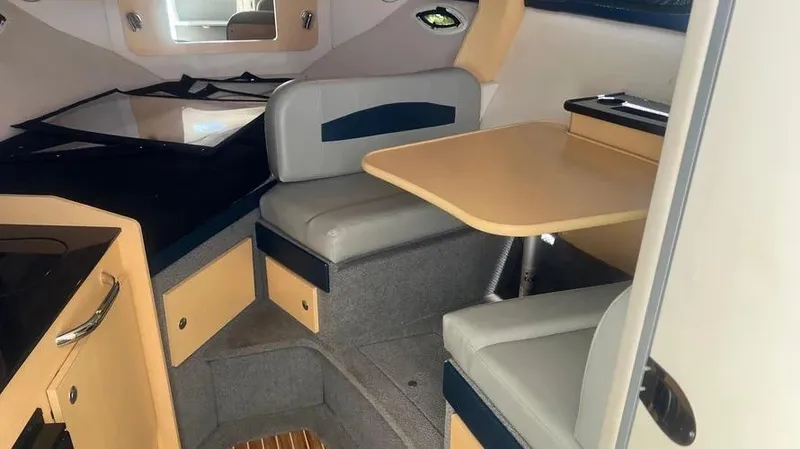 Slide: The Image of Interior of 2011 Bayliner 285 Cruiser with seating and table. - 26
