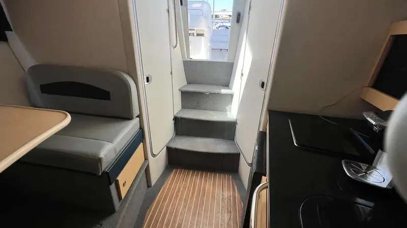 Slide: The Image of Interior of 2011 Bayliner 285 Cruiser with seating, steps, and kitchenette. - 31