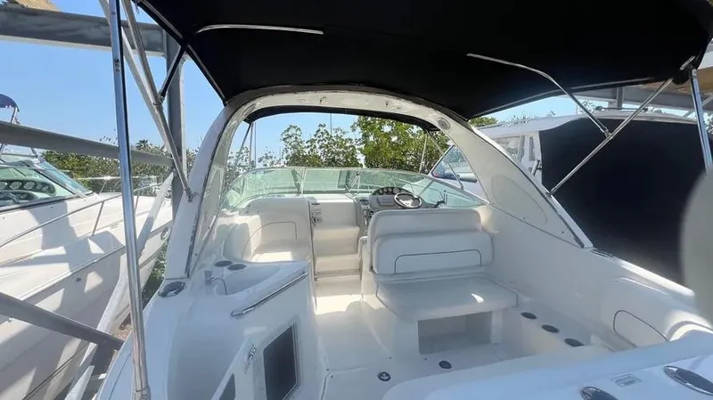Slide: The Image of 2011 Bayliner 285 Cruiser interior with seating and helm under canopy. - 36