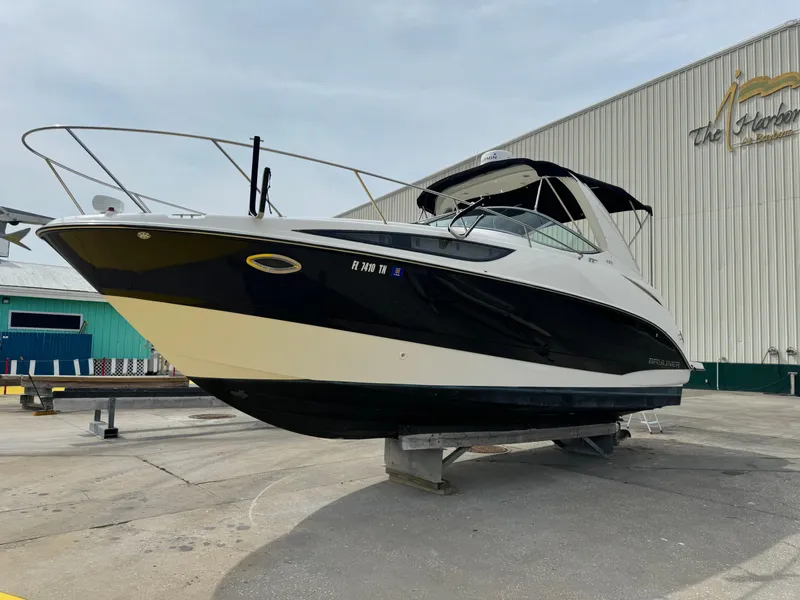 Slide: The Image of 2011 Bayliner 285 Cruiser boat on dry dock, black and white exterior. - 37