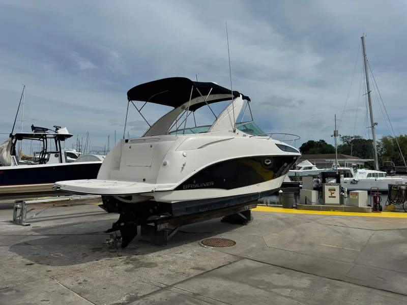 Slide: The Image of 2011 Bayliner 285 Cruiser docked at marina under cloudy sky. - 38