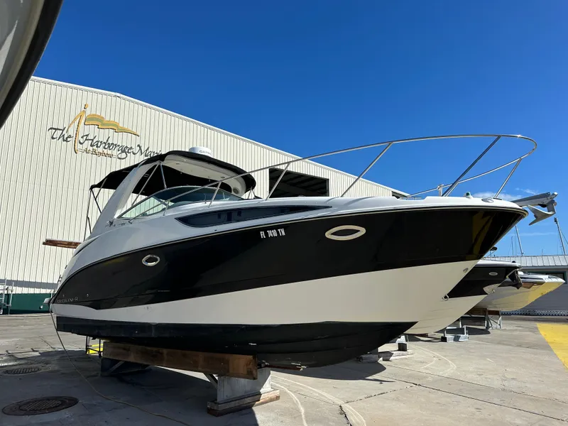 Slide: The Image of 2011 Bayliner 285 Cruiser boat on display at a marina. - 41