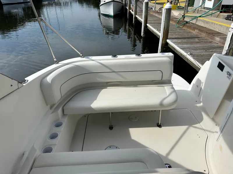 Slide: The Image of 2011 Bayliner 285 Cruiser boat interior with seating, docked at marina. - 5