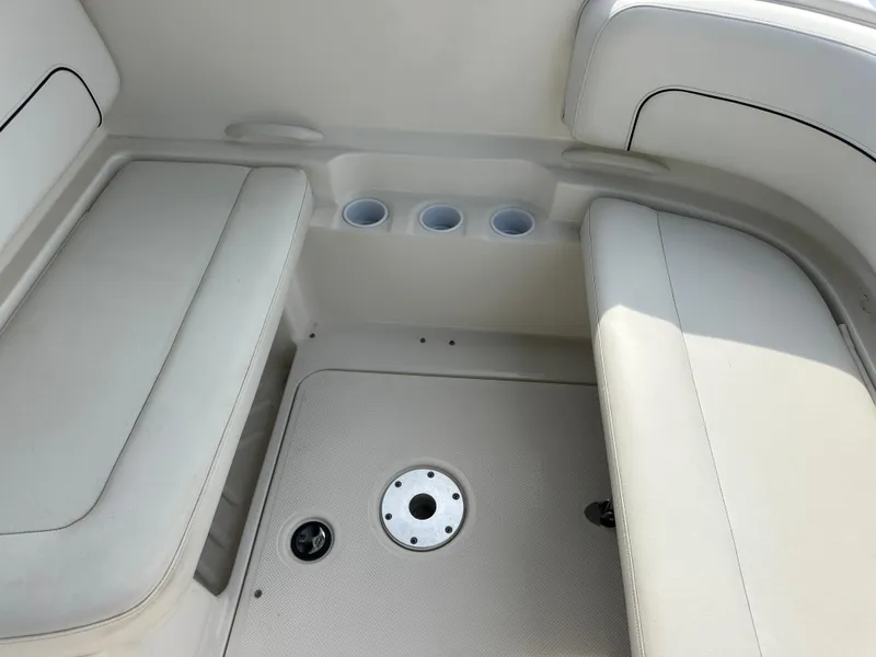 Slide: The Image of 2011 Bayliner 285 Cruiser interior seating area with cup holders and floor details. - 6