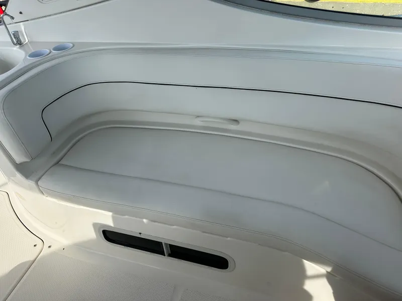 Slide: The Image of 2011 Bayliner 285 Cruiser interior seating area with cup holders. - 7