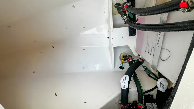 Slide: The Image of 2022 Pursuit S 268 Sport boat interior with visible plumbing and wiring. - 17