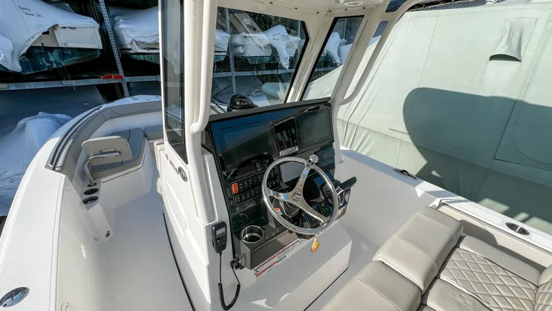 Slide: The Image of 2022 Pursuit S 268 Sport boat interior with steering wheel and seating. - 3