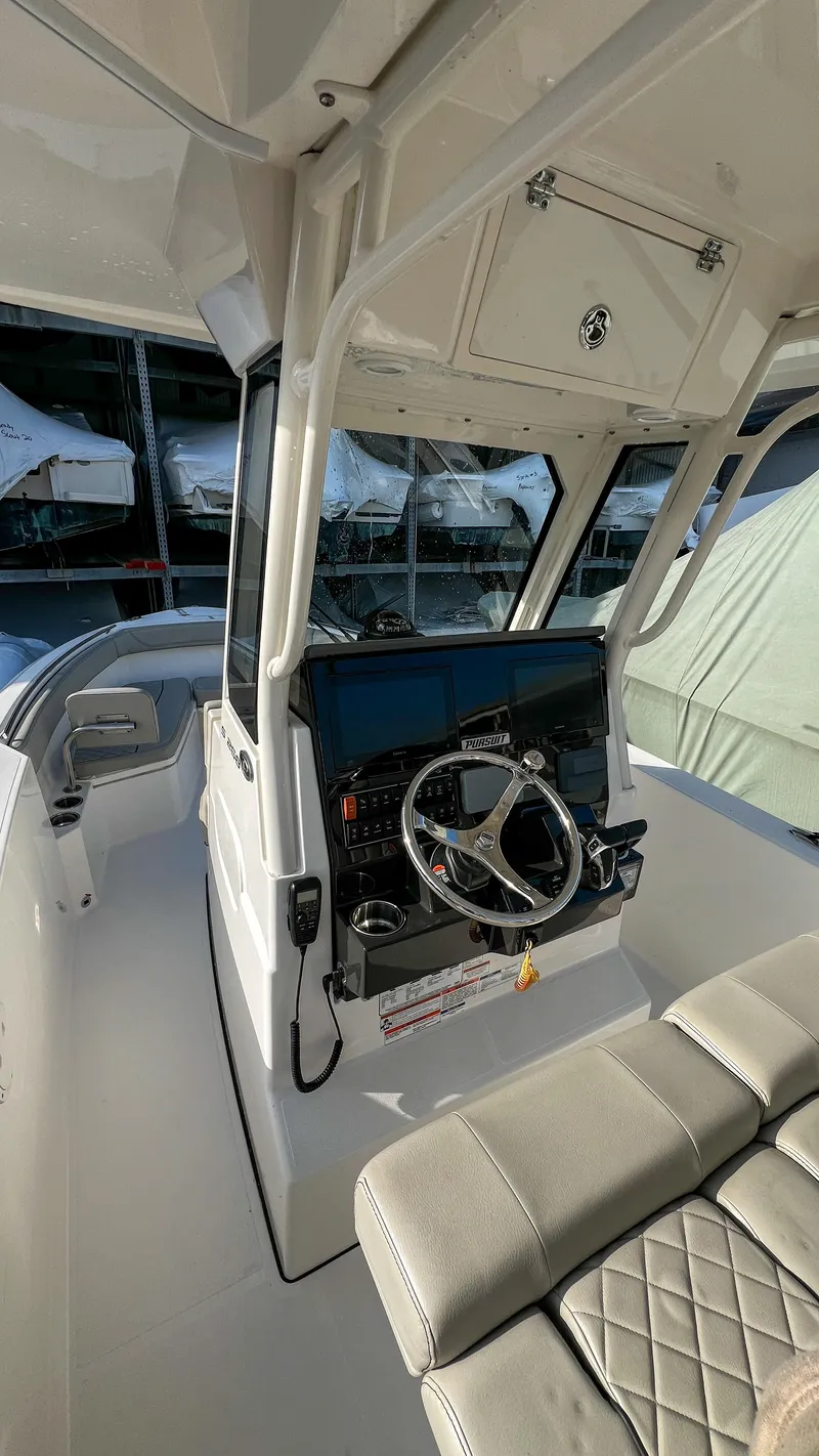 Slide: The Image of 2022 Pursuit S 268 Sport boat interior with steering wheel and seating. - 4