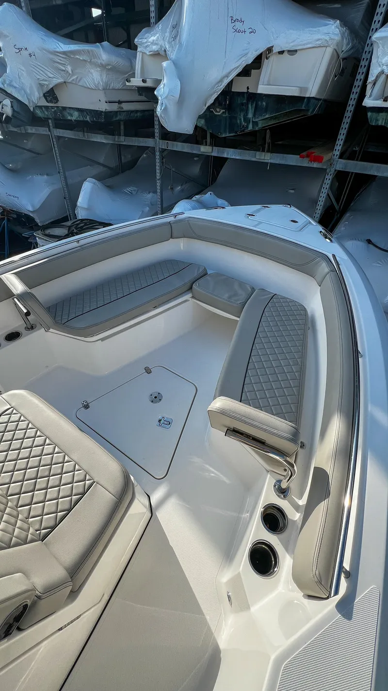 Slide: The Image of 2022 Pursuit S 268 Sport boat interior with cushioned seating and storage compartments. - 6