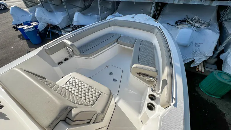 Slide: The Image of 2022 Pursuit S 268 Sport boat interior with cushioned seating and storage compartments. - 7
