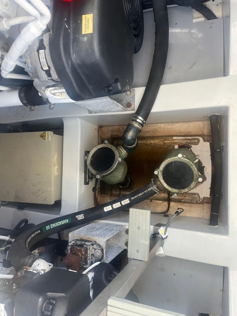 Slide: The Image of Engine compartment of 2013 Azimut 40 Flybridge with visible hoses and components. - 10