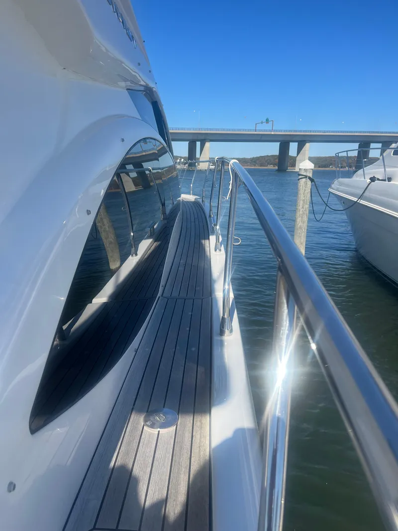 Slide: The Image of 2013 Azimut 40 Flybridge yacht docked near a bridge on a sunny day. - 15
