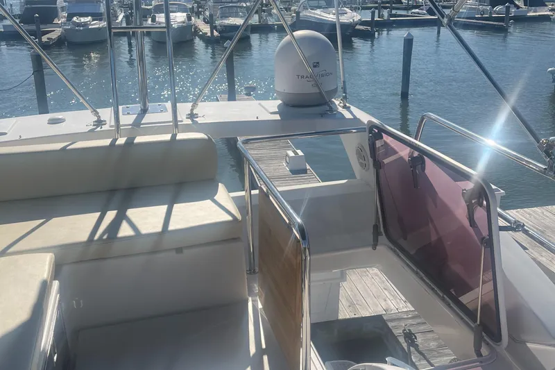 Slide: The Image of Azimut 40 Flybridge 2013 yacht docked at marina, featuring spacious seating and modern design. - 26