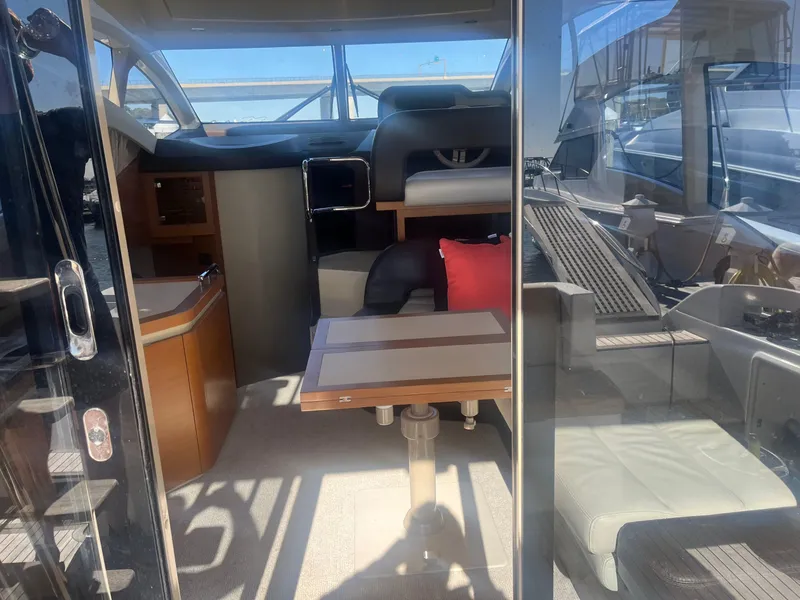 Slide: The Image of Interior view of 2013 Azimut 40 Flybridge yacht, featuring seating and table. - 31