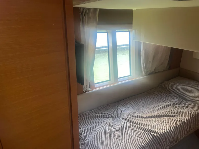 Slide: The Image of Cozy cabin interior of 2013 Azimut 40 Flybridge yacht with bed and window view. - 37