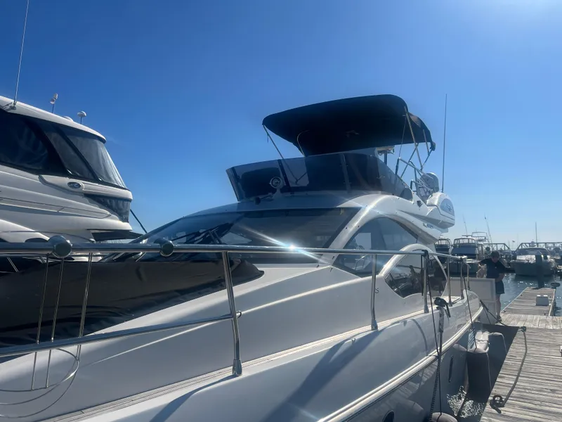 Slide: The Image of 2013 Azimut 40 Flybridge yacht docked under clear blue sky. - 5