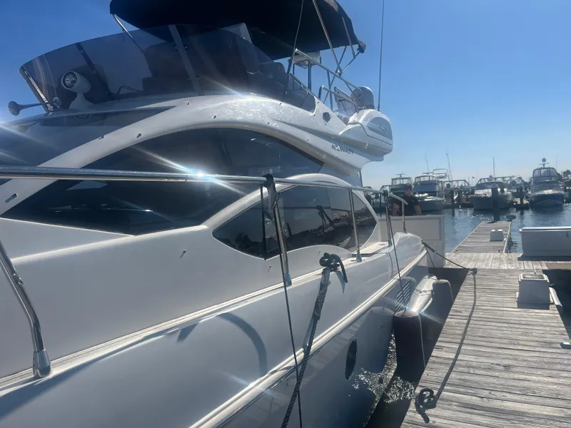 Slide: The Image of Azimut 40 Flybridge 2013 yacht docked at marina under clear blue sky. - 6