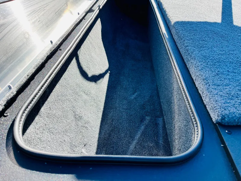 Slide: The Image of 2025 Tracker Pro Team 190 boat storage compartment, interior view. - 13