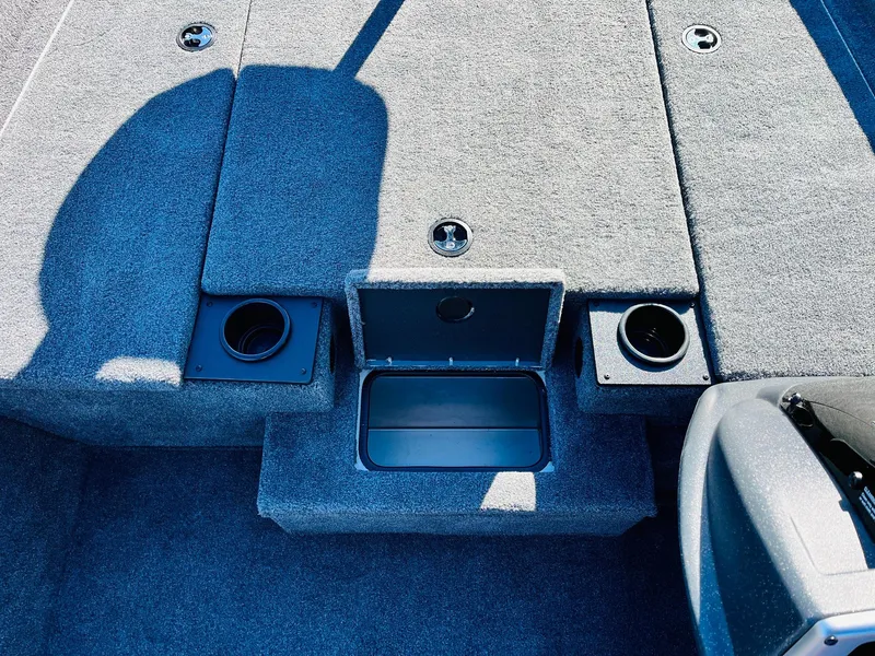 Slide: The Image of 2025 Tracker Pro Team 190 boat interior with storage compartments and cup holders. - 16