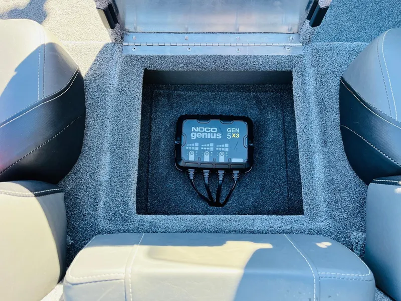 Slide: The Image of NOCO Genius GEN5X3 charger in 2025 Tracker Pro Team 190 boat compartment. - 22
