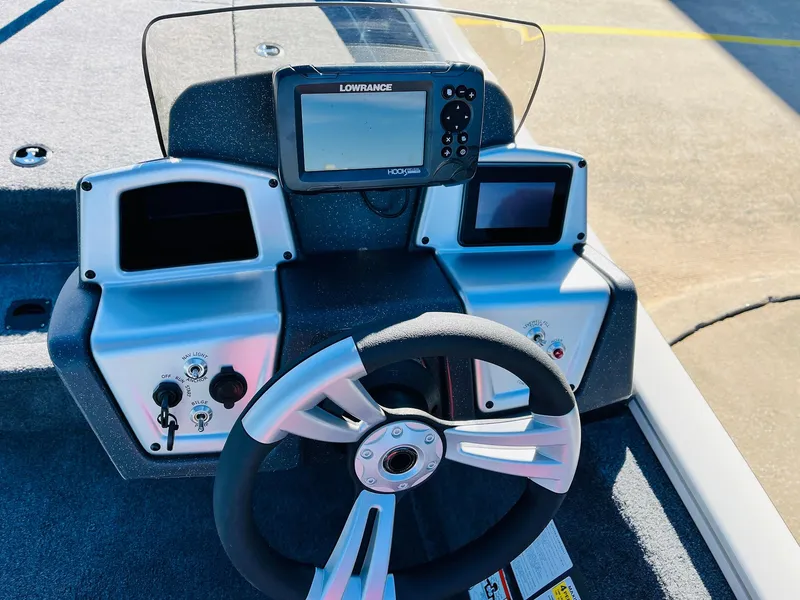 Slide: The Image of 2025 Tracker Pro Team 190 boat dashboard with steering wheel and Lowrance fishfinder. - 24