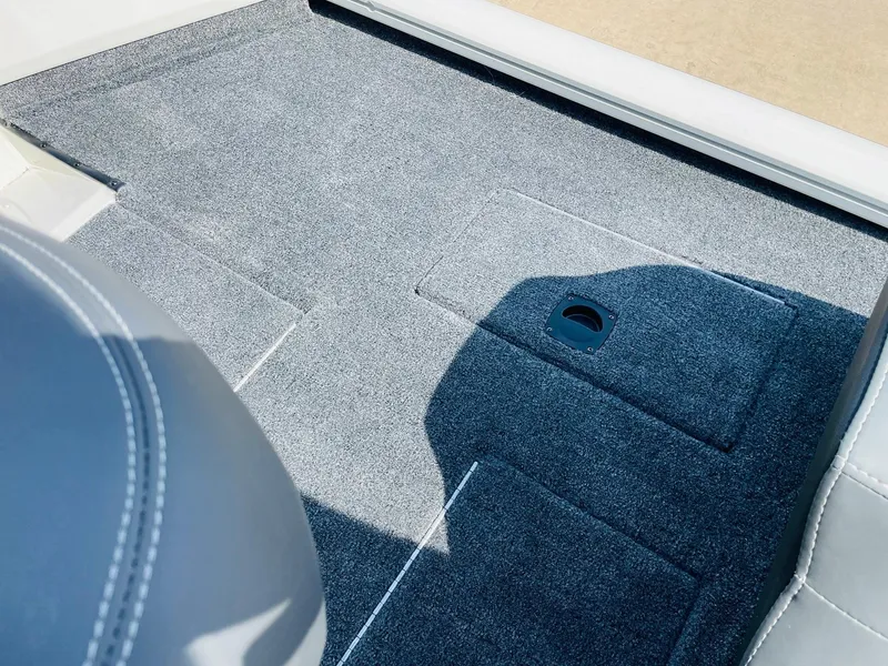 Slide: The Image of 2025 Tracker Pro Team 190 boat interior with gray carpet and seating. - 28