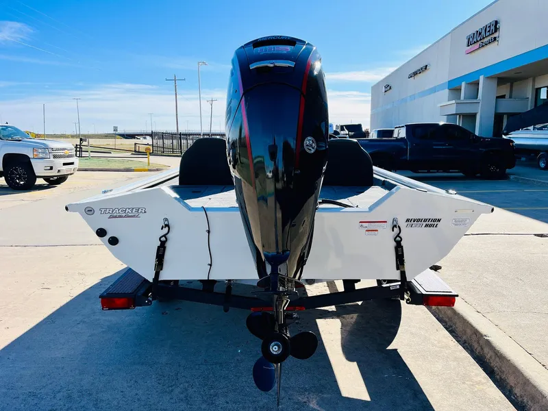 Slide: The Image of 2025 Tracker Pro Team 190 boat with motor, parked outdoors. - 6