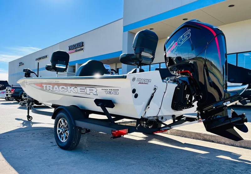 Slide: The Image of 2025 Tracker Pro Team 190 boat with powerful outboard motor, parked outside dealership. - 7