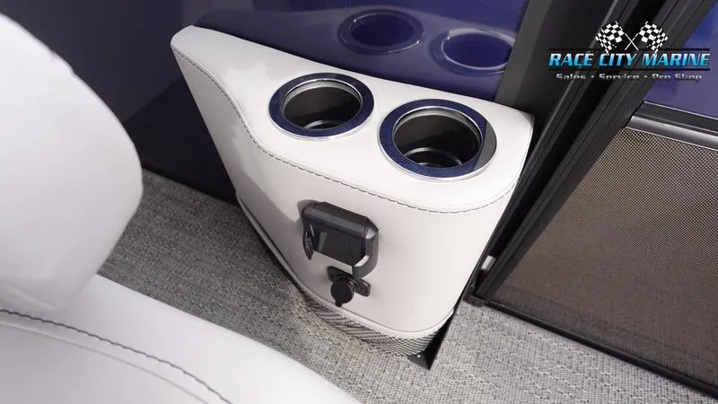 Slide: The Image of 2025 Barletta ARIA 22QC boat interior with dual cup holders and Race City Marine logo. - 19