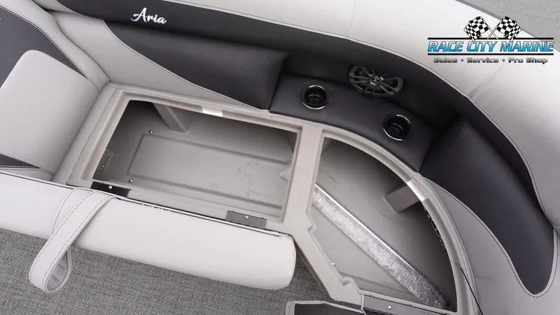Slide: The Image of Barletta ARIA 22QC 2025 boat interior with open storage compartment and cup holders. - 34