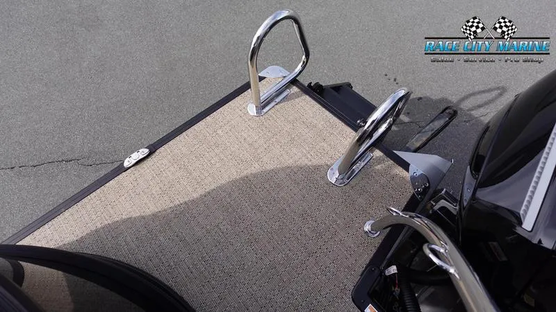 Slide: The Image of Barletta Cabrio 22QC 2025 boat deck with chrome railings and Race City Marine logo. - 11