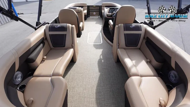 Slide: The Image of 2025 Barletta Cabrio 22QC pontoon boat interior with beige seating and modern dashboard. - 13