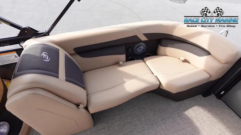 Slide: The Image of 2025 Barletta Cabrio 22QC boat interior with beige seating and speaker system. - 14