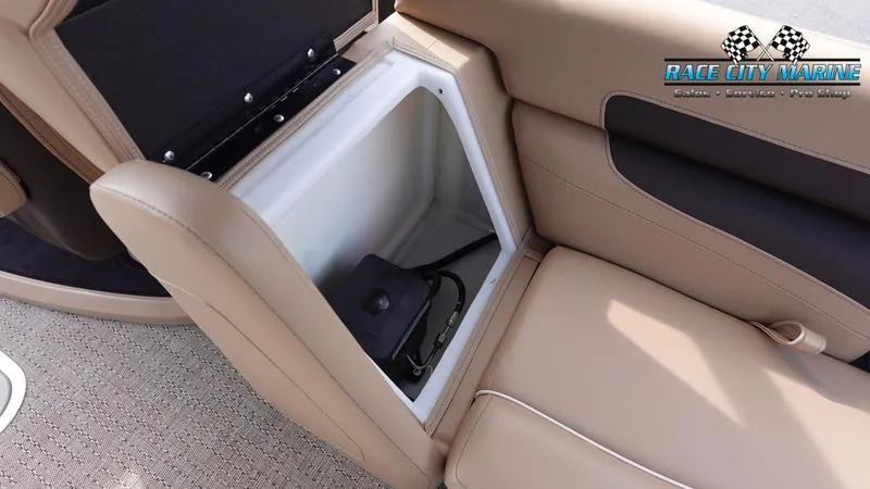 Slide: The Image of 2025 Barletta Cabrio 22QC boat seat storage compartment, beige upholstery, Race City Marine logo. - 19