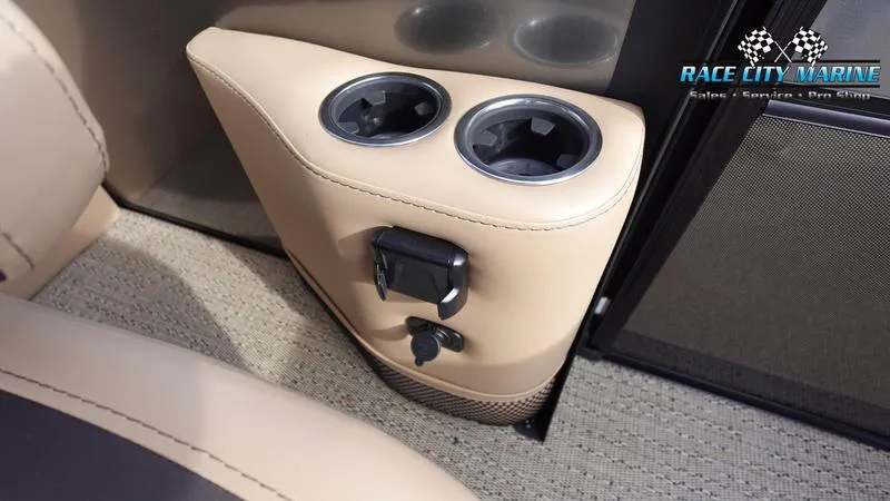 Slide: The Image of Barletta Cabrio 22QC 2025 boat interior with cup holders and beige upholstery. - 21