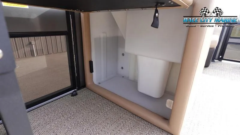 Slide: The Image of 2025 Barletta Cabrio 22QC storage compartment with beige interior and carpeted flooring. - 25