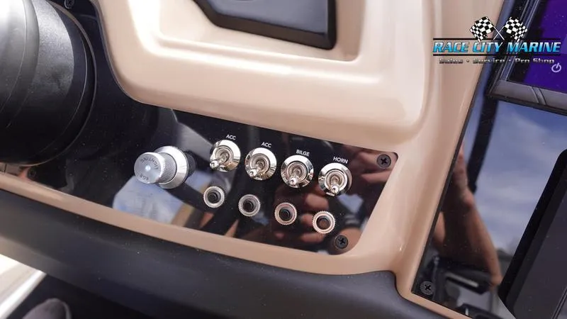 Slide: The Image of Control panel of 2025 Barletta Cabrio 22QC boat with switches and knobs. - 35