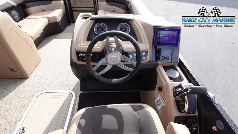 Slide: The Image of 2025 Barletta Cabrio 22QC boat interior with steering wheel and dashboard display. - 38